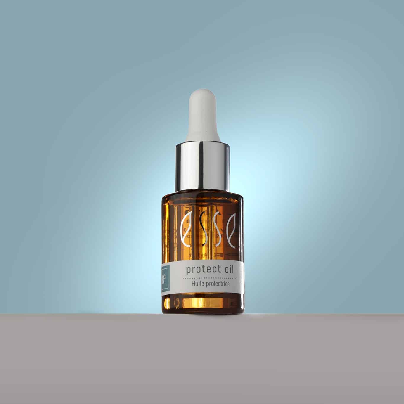 A small amber glass bottle with a dropper lid and metallic cap is positioned against a light blue background. The label on the bottle reads "protect oil" and includes small text beneath. The bottle is standing on a flat surface.