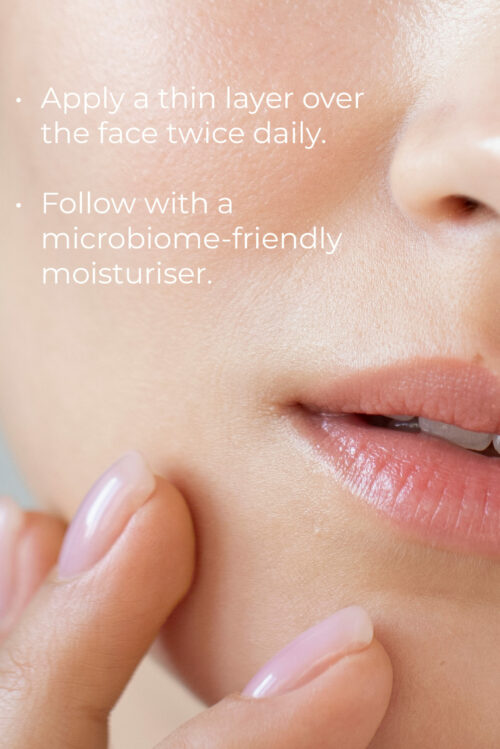Close-up of a person's lips, chin, and hand gently touching their face. The skin appears smooth and well-moisturized. Overlaid text provides skincare instructions: "Apply a thin layer of Esse Bakuchiol Serum over the face twice daily. Follow with a microbiome-friendly moisturizer.